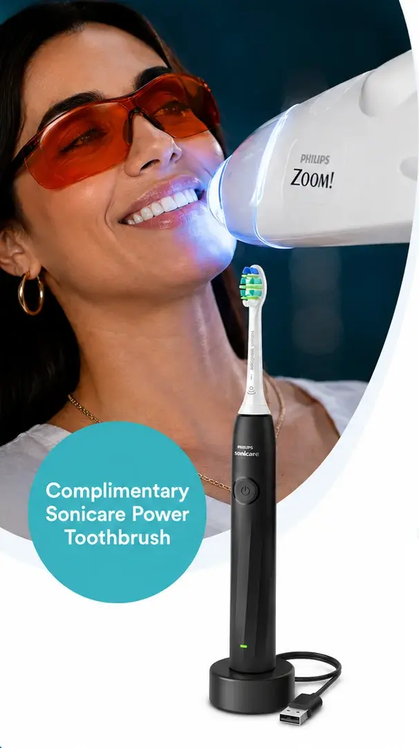 Woman receiving a Philips Zoom! in-chair teeth whitening treatment, with a complimentary Philips Sonicare 2100 BLACK electric toothbrush